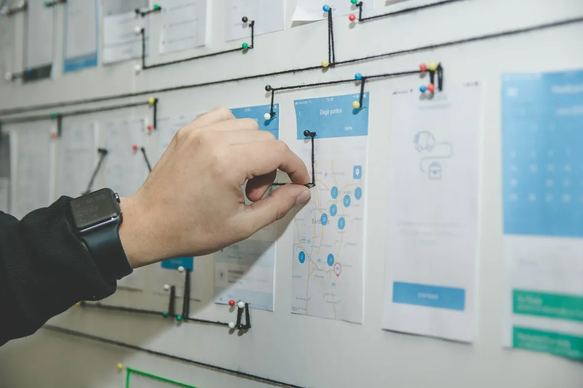 Person mapping out a workflow on a planning board — the kind of process design that precedes building an AI agent